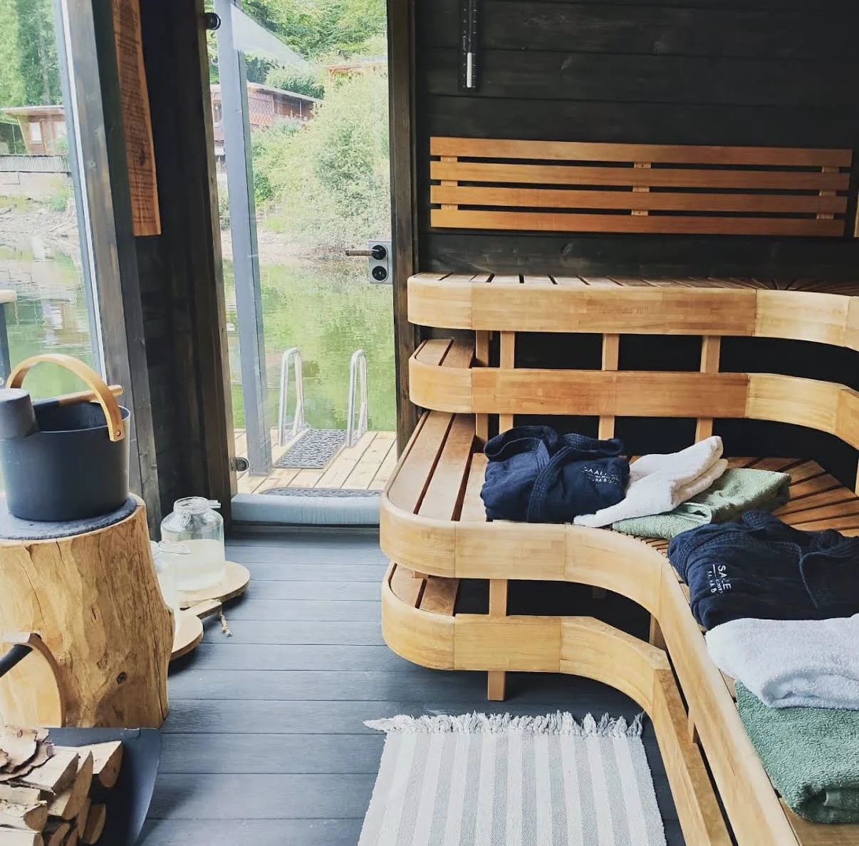 The SaaleSpa wood-fired sauna with curved benches and panoramic windows.