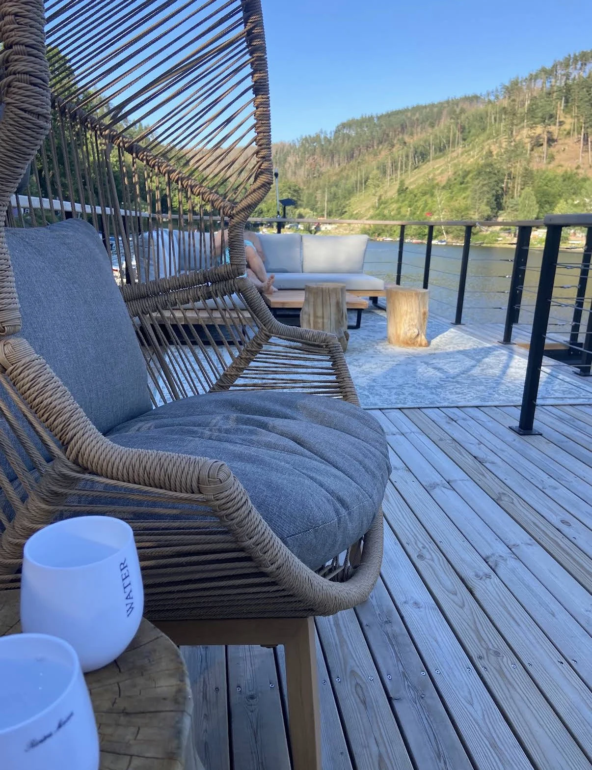 Original photograph of the SaaleSpa roof terrace with wicker chairs, sofas and a lake view.